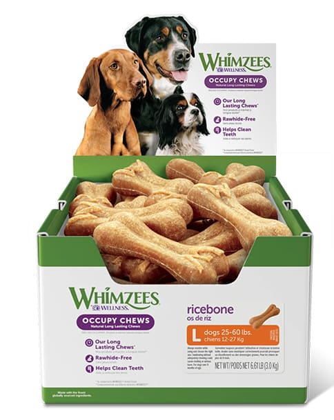 Owner giving dog 2 whimzees brushees